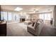Bright and airy living room featuring a large sectional sofa, a stone fireplace, and multiple skylights at 915 Vegas Valley Dr # 4, Las Vegas, NV 89109