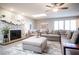 Open-concept living room with stone fireplace, ceiling fan, skylight, and large sectional sofa at 915 Vegas Valley Dr # 4, Las Vegas, NV 89109