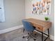 Home office space with a stylish wood desk, blue chair, and colorful wall art at 915 Vegas Valley Dr # 4, Las Vegas, NV 89109
