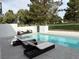 Relaxing backyard pool with lounge chairs, patio furniture, and views of a lush golf course at 916 Vegas Valley Dr, Las Vegas, NV 89109
