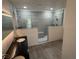 Modern bathroom showcasing the glass shower with gray stone style tile walls and black countertop sink at 916 Vegas Valley Dr, Las Vegas, NV 89109