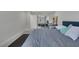 Spacious bedroom showcasing a gray bed and modern floors with a view into another bedroom with beds at 916 Vegas Valley Dr, Las Vegas, NV 89109