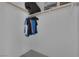 Empty walk-in closet with clothes hanging on a bar and white walls and gray hardwood style floors at 916 Vegas Valley Dr, Las Vegas, NV 89109