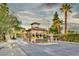 Welcoming entrance to the community with a stone guardhouse, lush landscaping, and decorative signage at 916 Vegas Valley Dr, Las Vegas, NV 89109