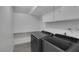 Bright laundry room featuring a washer and dryer with built in cabinetry above at 916 Vegas Valley Dr, Las Vegas, NV 89109