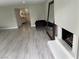 Open living room featuring a fireplace, modern floors, and an attached bathroom and bedroom at 916 Vegas Valley Dr, Las Vegas, NV 89109