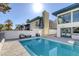 Back yard pool area with ample seating and green scenery at 916 Vegas Valley Dr, Las Vegas, NV 89109