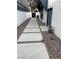 Modern side yard with stone pathway, rock landscaping, and neutral colors providing simple elegance and utility at 916 Vegas Valley Dr, Las Vegas, NV 89109