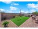 Beautiful backyard with artificial turf, a pool, hardscaping and outdoor seating at 9212 Lunar Effect St, Las Vegas, NV 89143