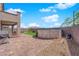 The backyard has a pool, covered patio, artificial turf, hardscaping, and mountain views at 9212 Lunar Effect St, Las Vegas, NV 89143
