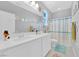Bright bathroom featuring double sinks, a large mirror, and a window for natural light at 9212 Lunar Effect St, Las Vegas, NV 89143