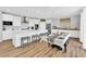 Open-concept kitchen and dining area with white cabinets and wood flooring at 9212 Lunar Effect St, Las Vegas, NV 89143