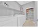 Convenient laundry room with washer, dryer, storage shelves, and ample counter space at 9212 Lunar Effect St, Las Vegas, NV 89143