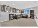 Open concept living room with sports memorabilia and views from large windows at 9212 Lunar Effect St, Las Vegas, NV 89143