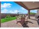 Enjoy outdoor living on this covered patio with a table, chairs, and artificial turf at 9212 Lunar Effect St, Las Vegas, NV 89143