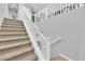 Carpeted staircase with a white banister leading upstairs at 9212 Lunar Effect St, Las Vegas, NV 89143