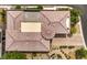 Detailed aerial shot of a unique roof design on a beige single-story home, featuring landscaped grounds and a cozy outdoor space at 9928 Regency Square Ave, Las Vegas, NV 89148