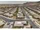 Picturesque aerial perspective of a beige single-story home nestled in a community, close to neighborhood streets and natural desert terrain at 9928 Regency Square Ave, Las Vegas, NV 89148