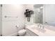 This is a well-lit bathroom with white tile floors, toilet, sink, and a large mirror at 9928 Regency Square Ave, Las Vegas, NV 89148