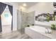 Elegant bathroom showcasing a modern glass enclosed shower, soaking tub and artistic decor at 9928 Regency Square Ave, Las Vegas, NV 89148