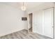 Bedroom with closet, chandelier, and gray wood-look floors at 9928 Regency Square Ave, Las Vegas, NV 89148