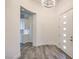 Light-filled entryway with tiled floors, modern lighting, and a view into the kitchen at 9928 Regency Square Ave, Las Vegas, NV 89148
