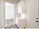 Hallway area with white cabinets and view to a room with a chandelier at 9928 Regency Square Ave, Las Vegas, NV 89148