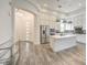 Open-concept kitchen with stainless steel appliances, white cabinetry, and a large island at 9928 Regency Square Ave, Las Vegas, NV 89148
