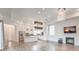 Open-concept living space featuring a modern kitchen, dining area, and a cozy fireplace at 9928 Regency Square Ave, Las Vegas, NV 89148