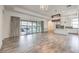 Spacious living room with tile floors, modern lighting, and sliding glass doors to the outdoor patio at 9928 Regency Square Ave, Las Vegas, NV 89148