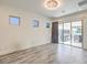 Bright living space with tile floors, modern lighting, and sliding glass doors to the outdoor patio at 9928 Regency Square Ave, Las Vegas, NV 89148