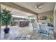 Inviting outdoor living space with a kitchen, bar seating, lounge area, and stylish decor for relaxation and entertainment at 9928 Regency Square Ave, Las Vegas, NV 89148