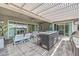 Outdoor living area featuring an outdoor kitchen, bar seating, and a covered pergola providing shade and comfort at 9928 Regency Square Ave, Las Vegas, NV 89148