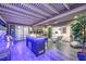 Covered patio with a large island, stone countertops, stainless grill, and seamless access to the home's interior at 9928 Regency Square Ave, Las Vegas, NV 89148