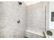 Close up view of tiled walk-in shower with a built-in bench and sleek fixtures at 9928 Regency Square Ave, Las Vegas, NV 89148