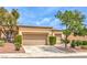 Charming single-story home with a well-maintained front yard and two-car garage at 9948 Bundella Dr, Las Vegas, NV 89134