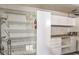 Spacious garage with installed shelves and white storage cabinets for organizing tools and equipment at 9948 Bundella Dr, Las Vegas, NV 89134