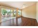 Sunlit living room with wood floors, a ceiling fan, and sliding glass doors opening to the backyard at 9948 Bundella Dr, Las Vegas, NV 89134