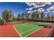 Well-maintained tennis courts with a green and red surface, perfect for recreational play at 9948 Bundella Dr, Las Vegas, NV 89134