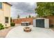 A serene backyard with a stone fire pit, storage shed and hot tub offers a relaxing outdoor space at 1417 Brushback Ave, Henderson, NV 89074