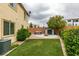 Expansive backyard with artificial grass, storage shed, hot tub, and fire pit provides outdoor fun and relaxation at 1417 Brushback Ave, Henderson, NV 89074