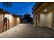 String lights illuminate the brick-paved backyard, creating a cozy ambiance for the outdoor space at 1417 Brushback Ave, Henderson, NV 89074