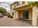 Outdoor covered patio featuring brick flooring, a hot tub, and large sliding glass doors at 1417 Brushback Ave, Henderson, NV 89074