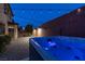 Backyard oasis featuring a glowing hot tub and overhead string lights, creating a relaxing atmosphere for evenings at 1417 Brushback Ave, Henderson, NV 89074