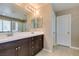 Bathroom featuring double sinks with dark wood cabinets, white countertops, and framed mirrors above at 1417 Brushback Ave, Henderson, NV 89074