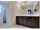 Bathroom featuring vanity with large mirror and tub/shower combo with shower curtain at 1417 Brushback Ave, Henderson, NV 89074