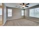 Spacious primary bedroom with natural light, carpet flooring, and a ceiling fan at 1417 Brushback Ave, Henderson, NV 89074