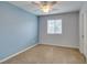 Bedroom featuring neutral carpet, one window allowing for natural light, and a ceiling fan at 1417 Brushback Ave, Henderson, NV 89074