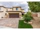 Lovely two-story home with a two-car garage, desert-friendly landscaping, and a brick-paved driveway at 1417 Brushback Ave, Henderson, NV 89074