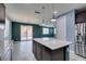 Eat-in kitchen with granite island, stainless steel appliances, and access to the backyard at 1417 Brushback Ave, Henderson, NV 89074
